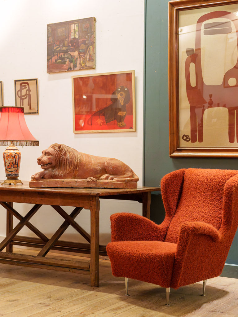 Antique brick-red recumbent lion statue