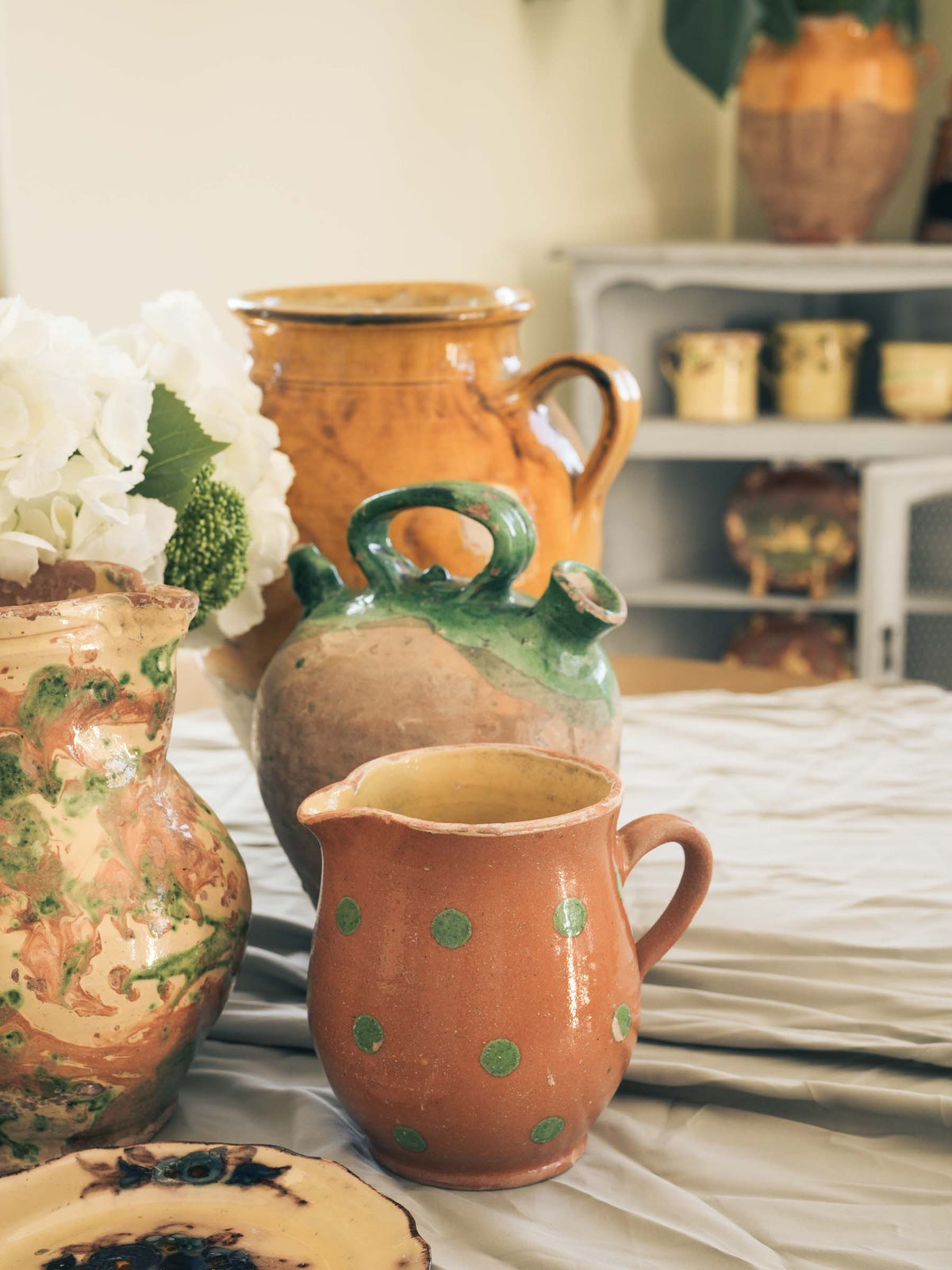 Rustic green polka-dot ceramic pitcher