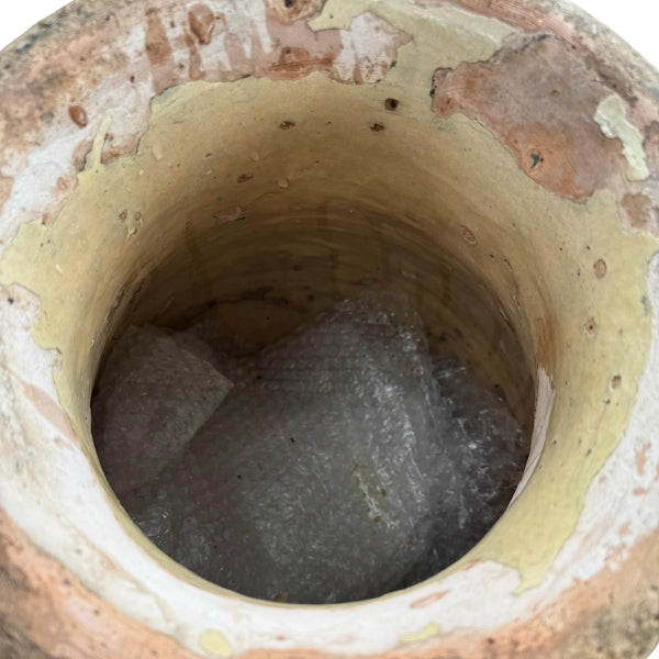 Timeworn glazed clay vessel