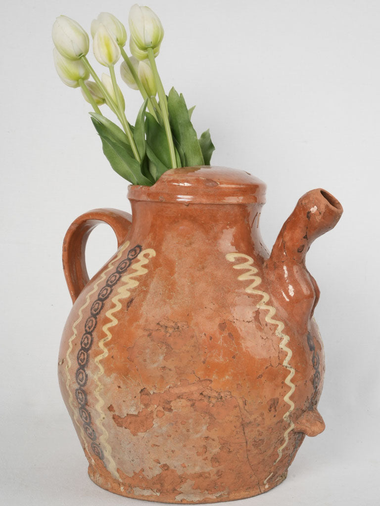 Ornate handmade orange-brown glazed pitcher