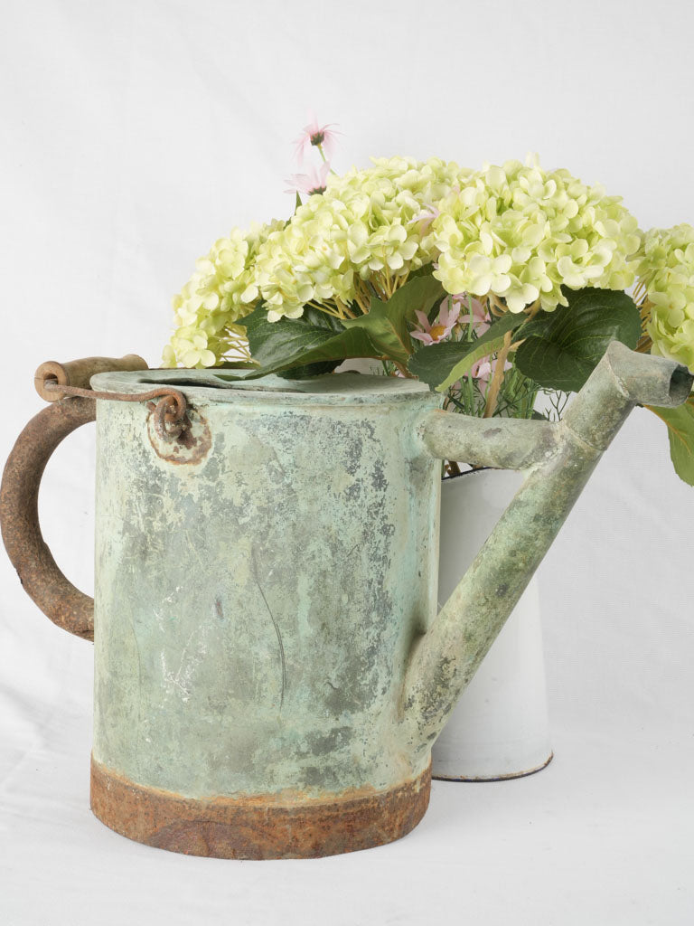 Time-worn verdigris patina watering implement
