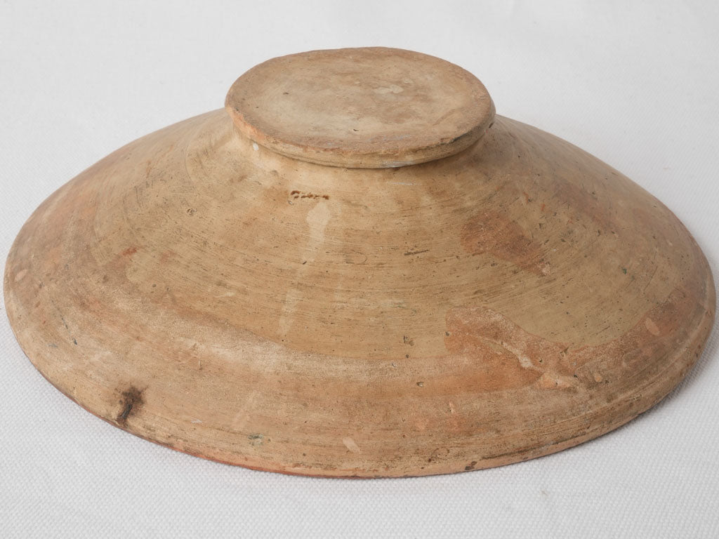 Squiggle adorned traditional French terracotta plate