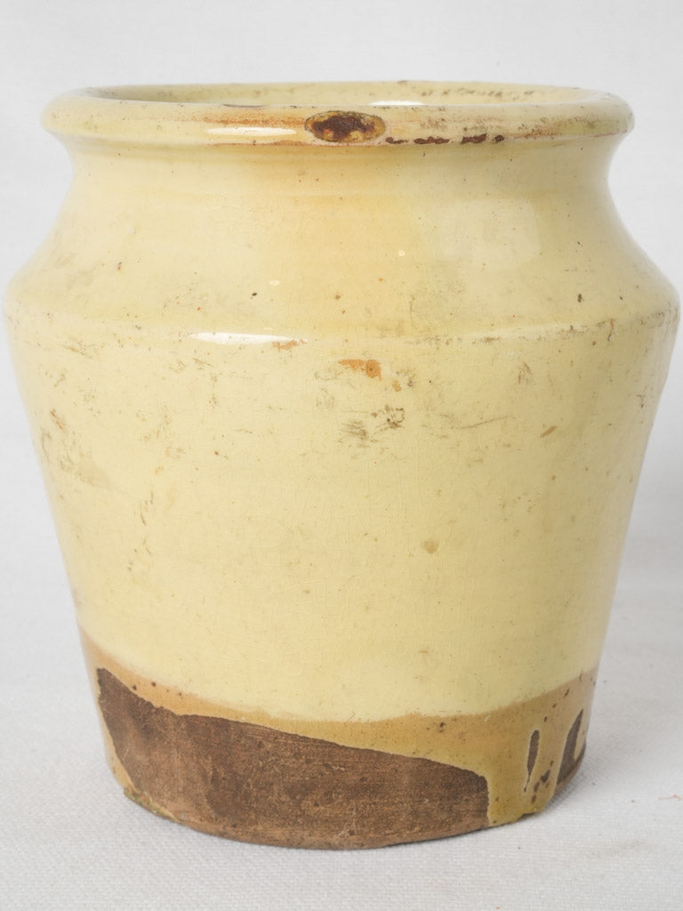 Aged yellow ceramic floral vase