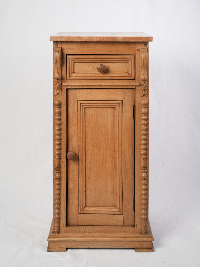 Timeworn marble-top bedside cabinet