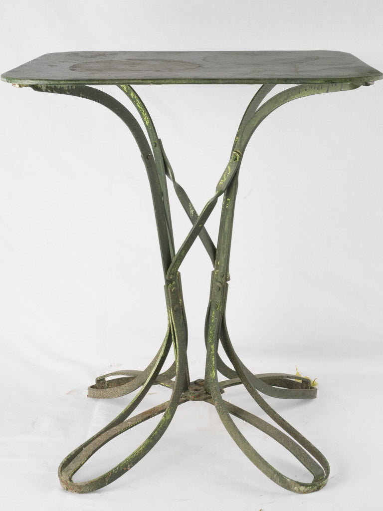 Classic riveted loop-footed table