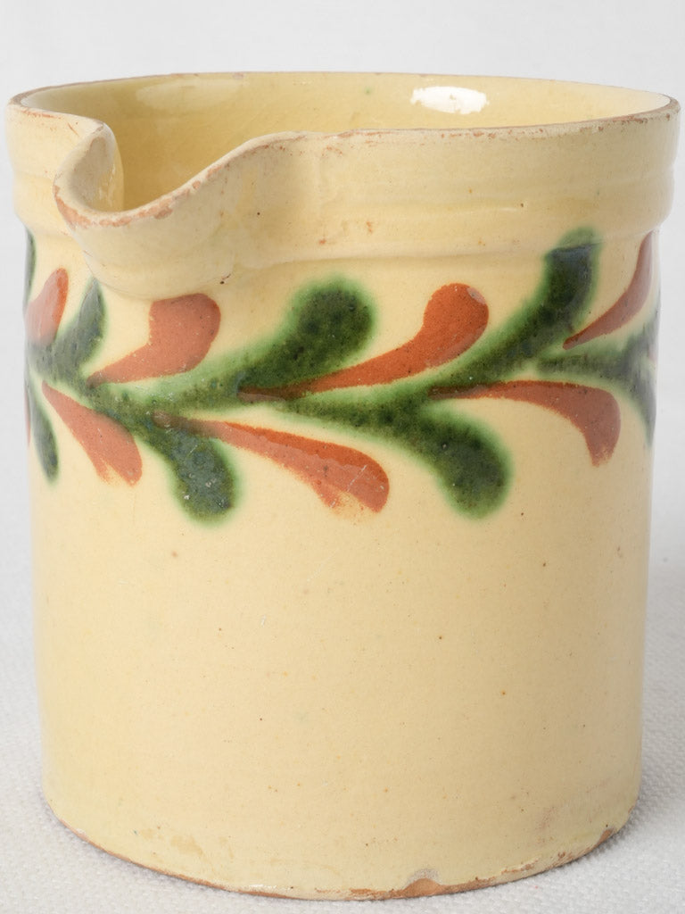 Aged yellow glazed terracotta jug