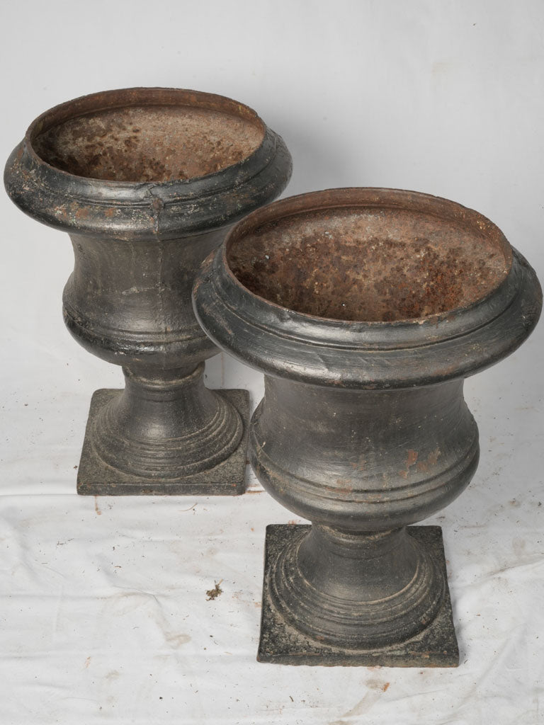 Opulent black cast iron urns