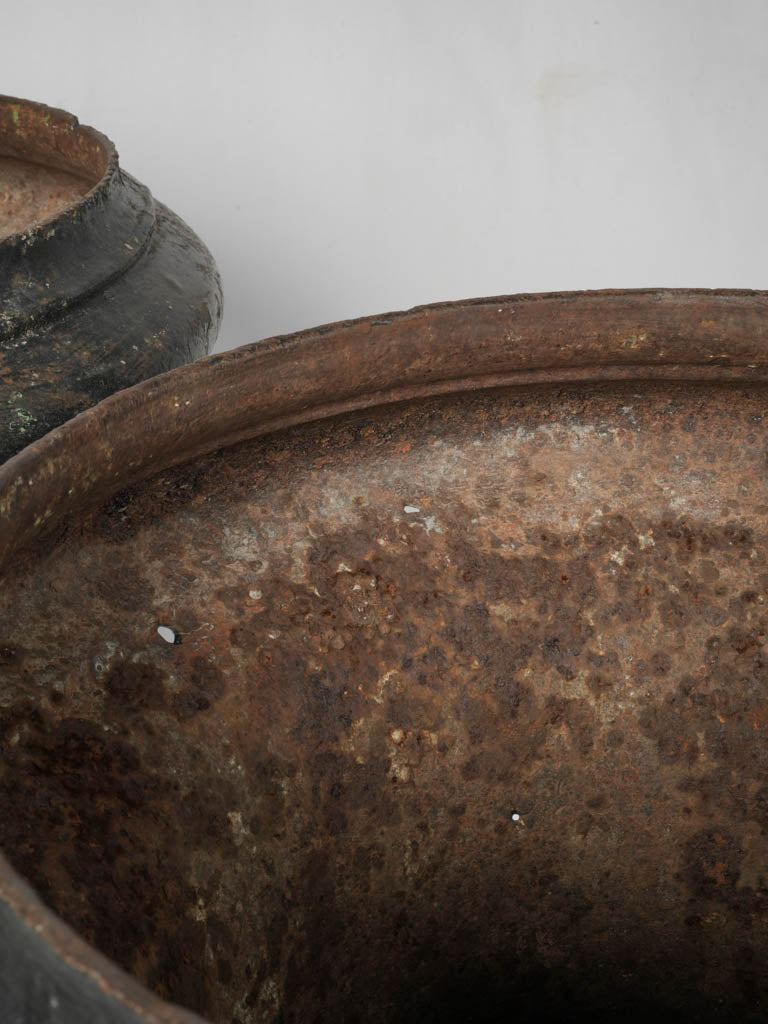Stately black cast iron urns