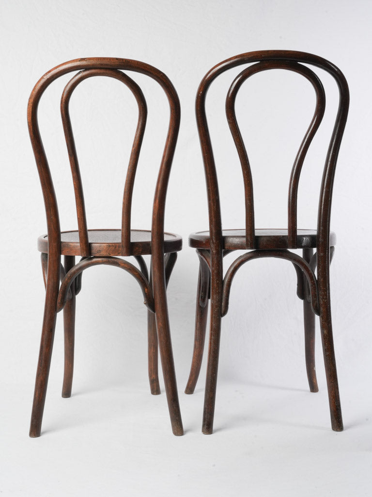 Dark-stained hoop back chairs
