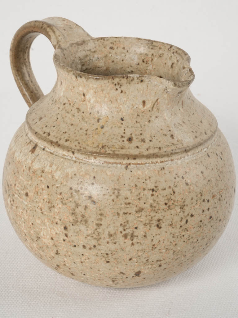 Rustic hand-thrown clay pitcher