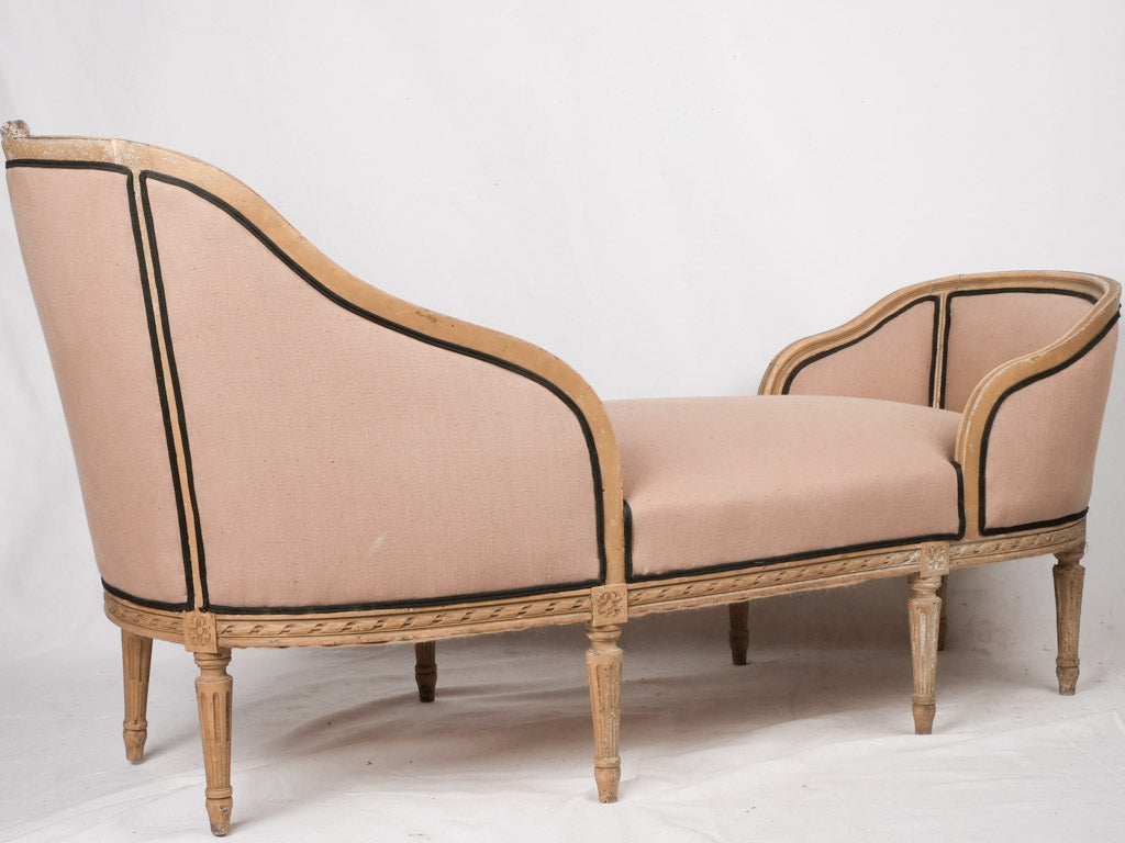 Period-appropriate fabric-upholstered chaise longue