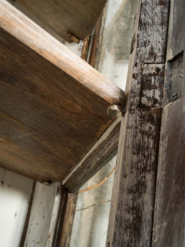 Richly layered wooden vitrine cabinet