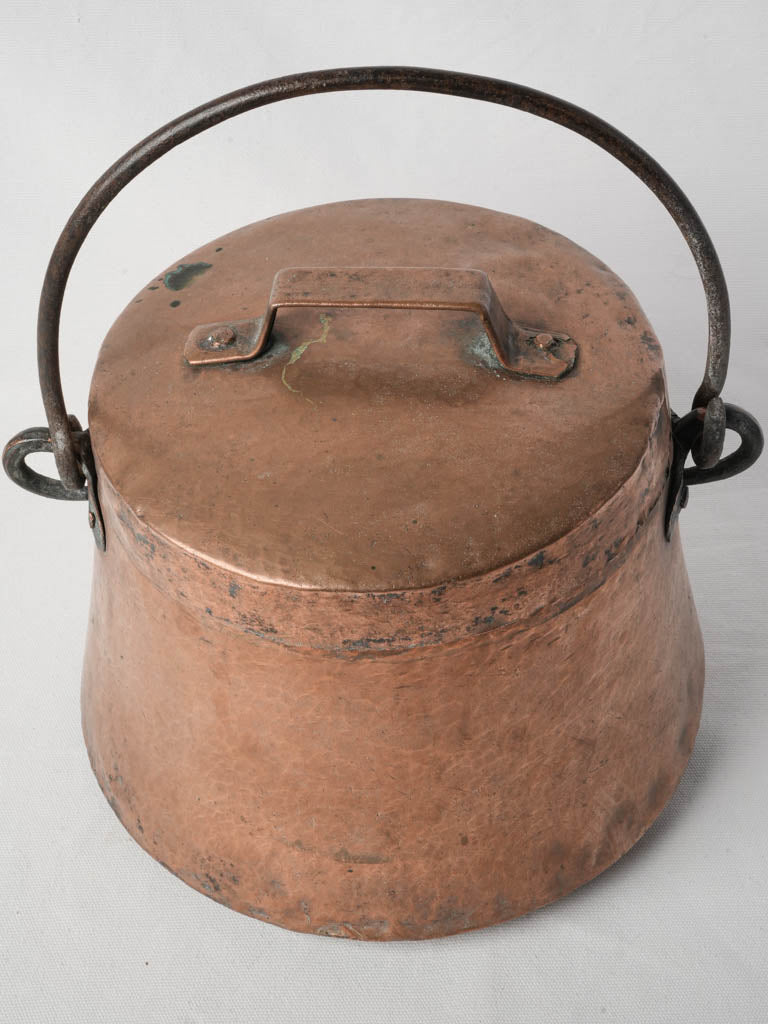 Rustic iron-handled copper bucket