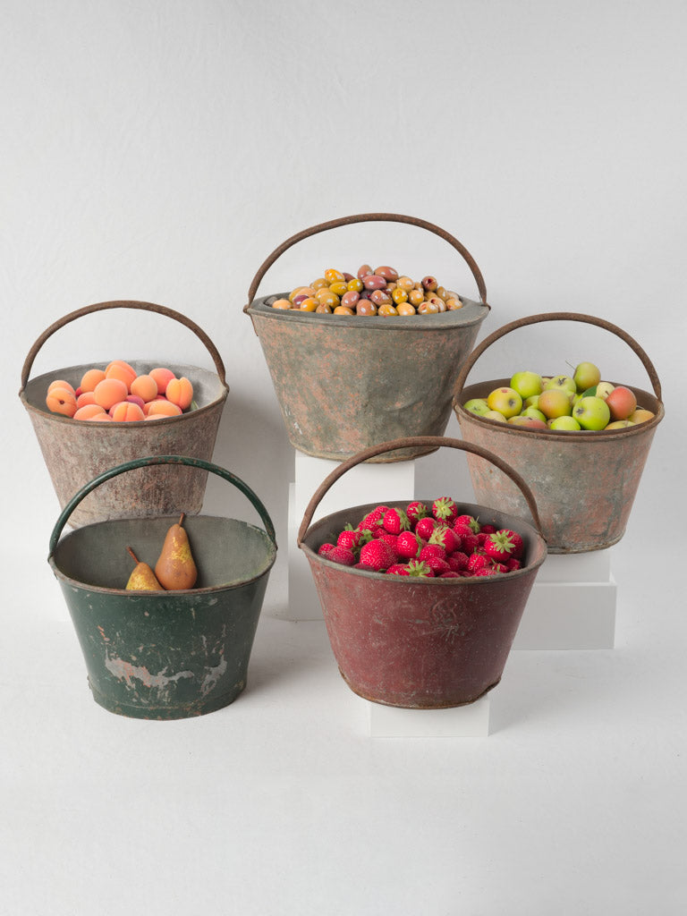 Aged metal fruit gathering containers