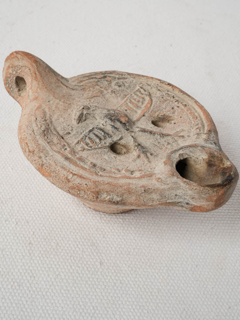 Vintage terracotta lighting piece emblem