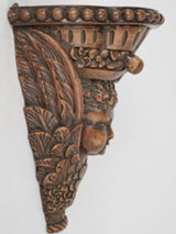 Ornate walnut face wall bracket