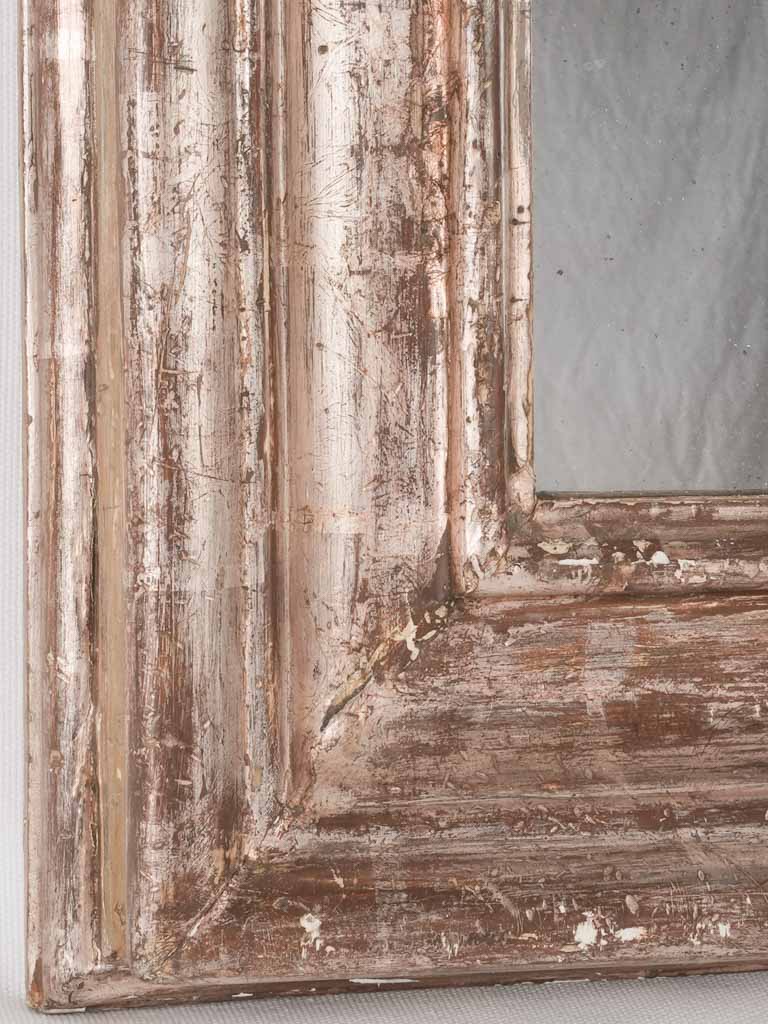 Timeworn ornate mirror with patina
