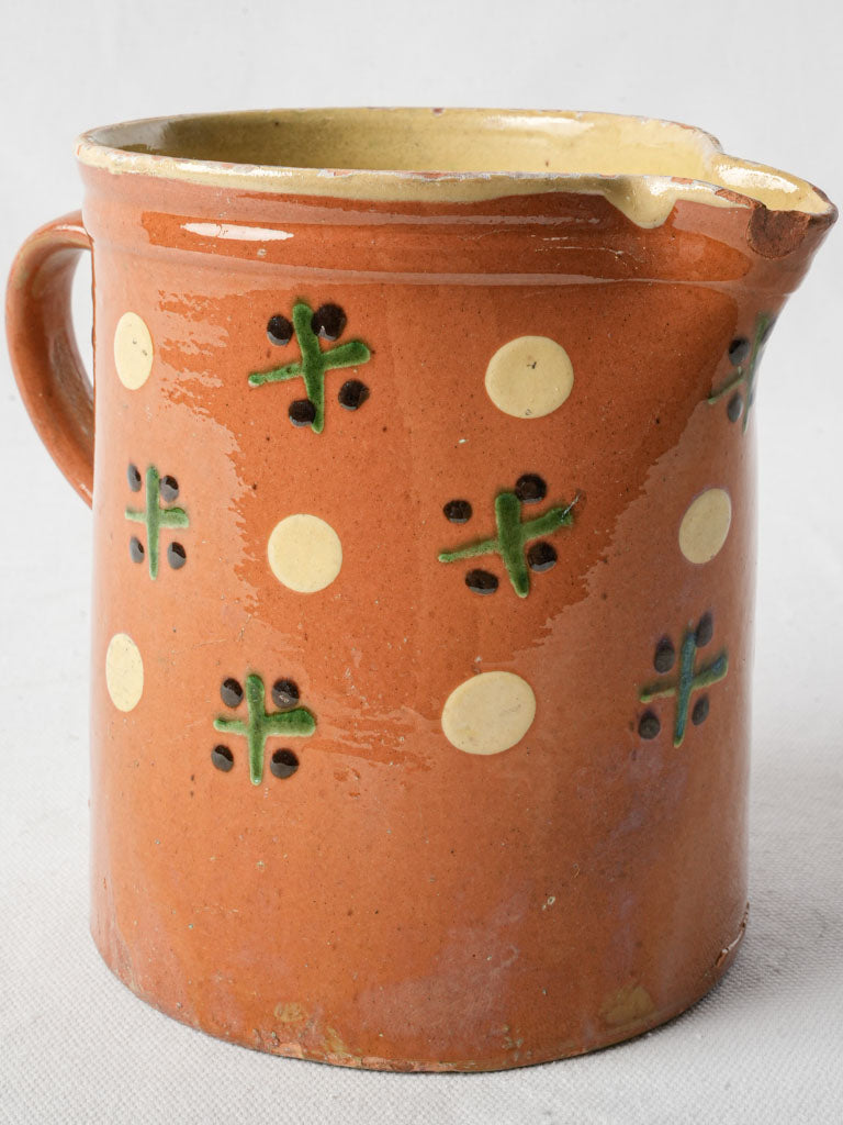 Terracotta cross-and-dot motif pottery
