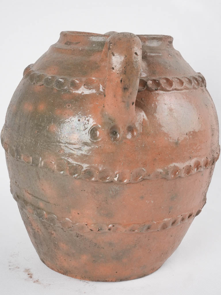 Old-world French walnut oil pitcher