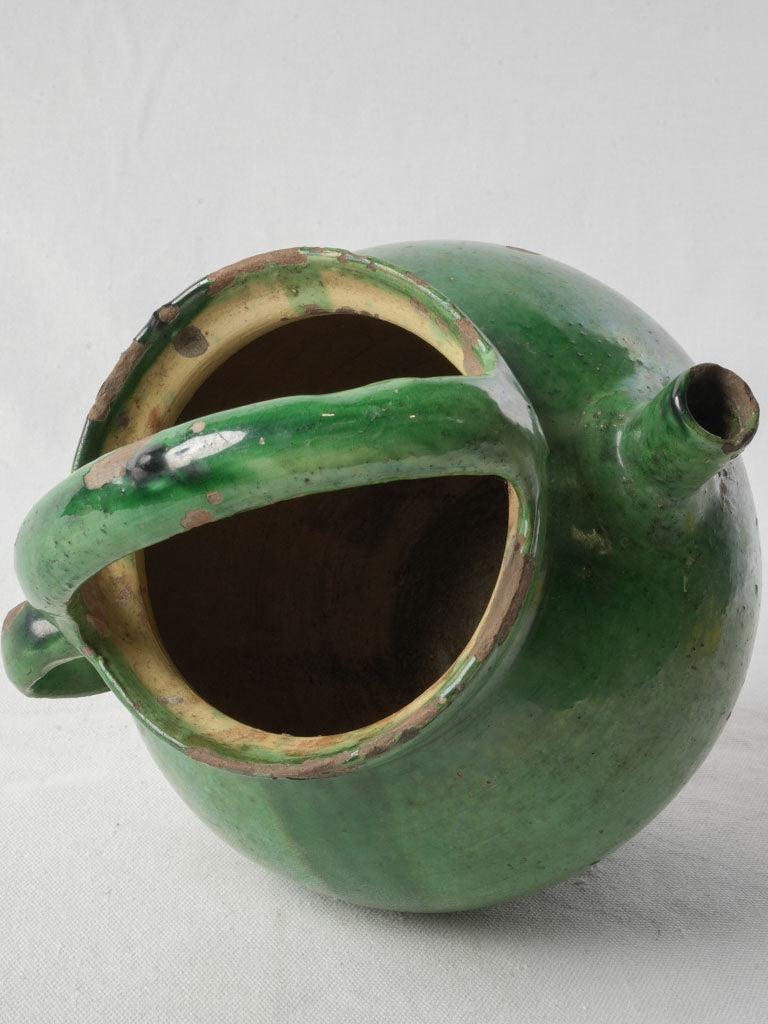 Green glazed rustic pottery pitcher