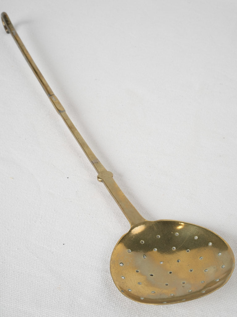 Antique brass skimmer slotted spoon