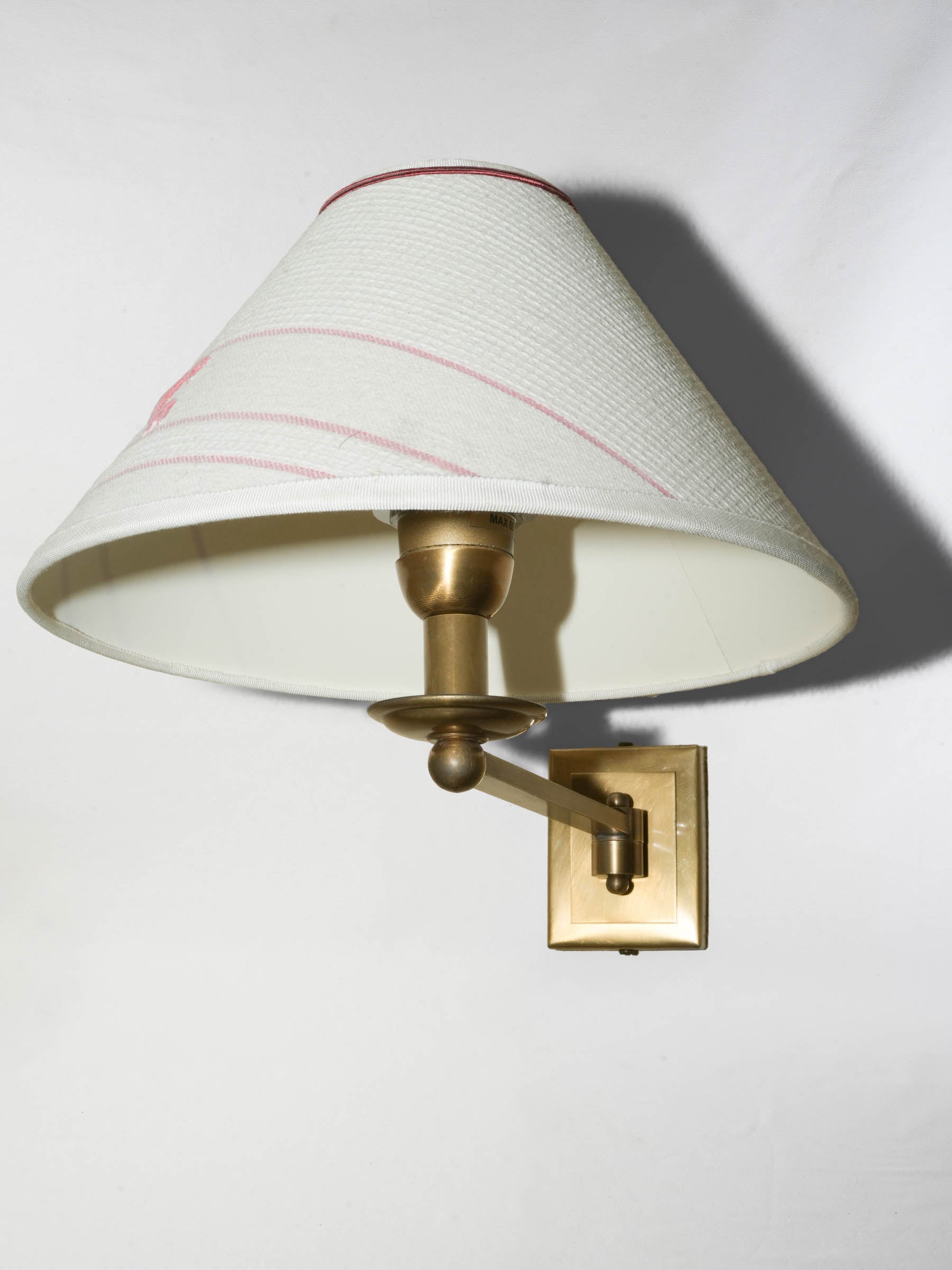 Pair of brass wall sconces with monogrammed ‘C’ shades