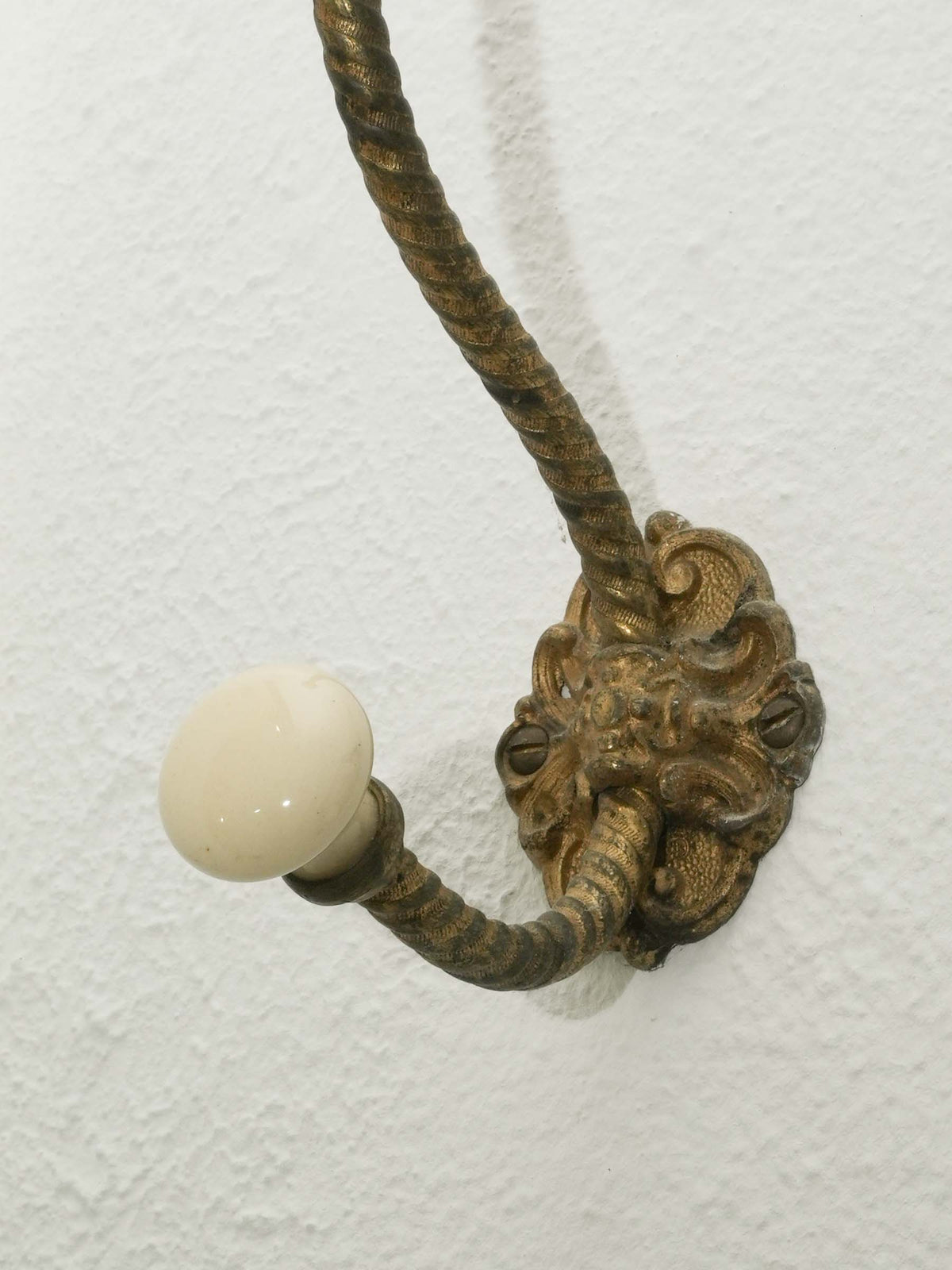 Brass Wall Hook with Porcelain Tips and Foliate Mount