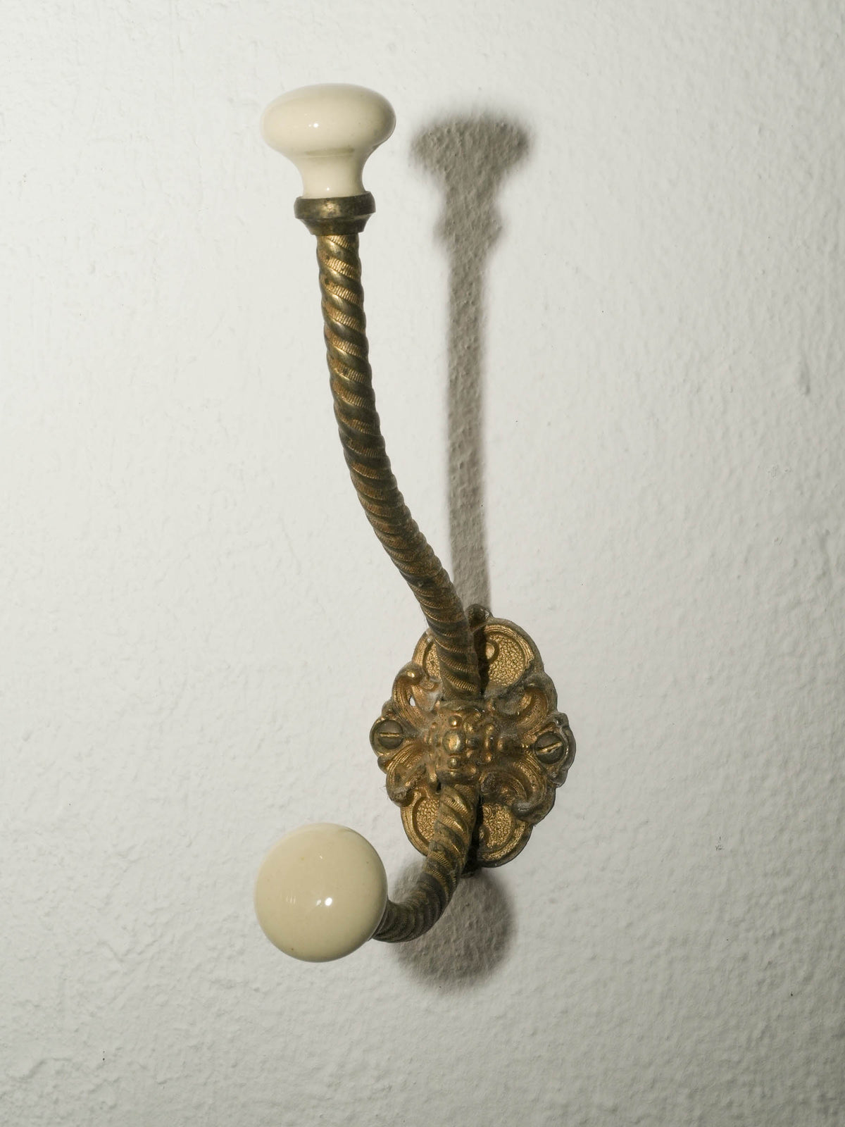 Brass Wall Hook with Porcelain Tips and Foliate Mount