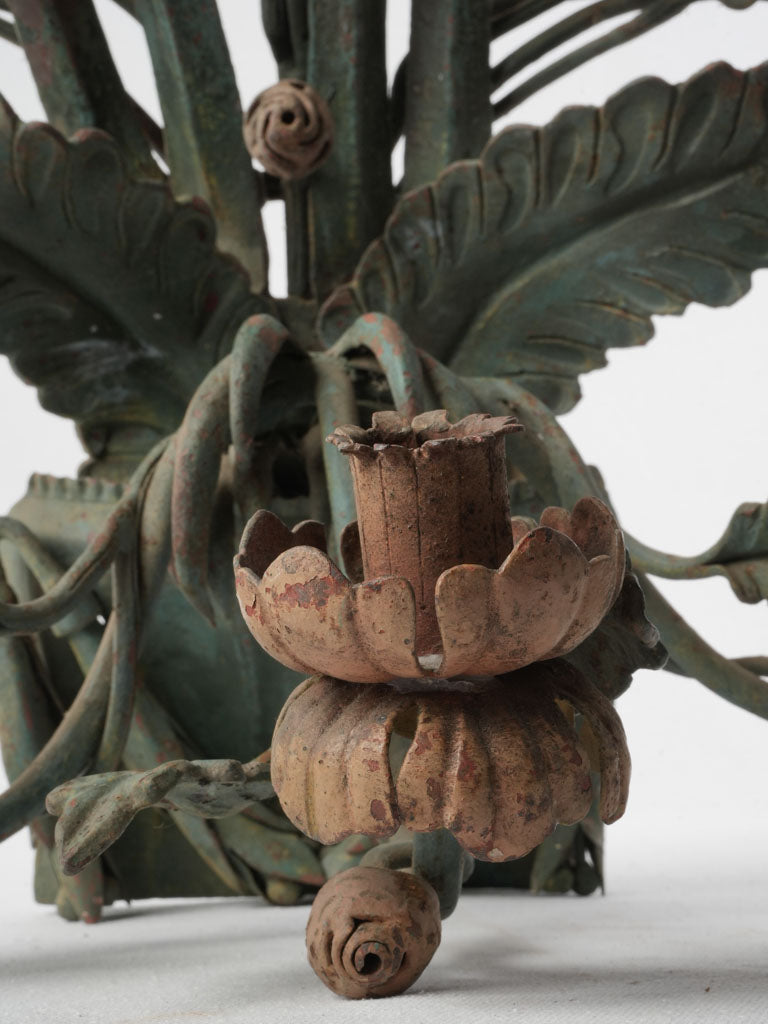 Muted patinated finish candle sconce