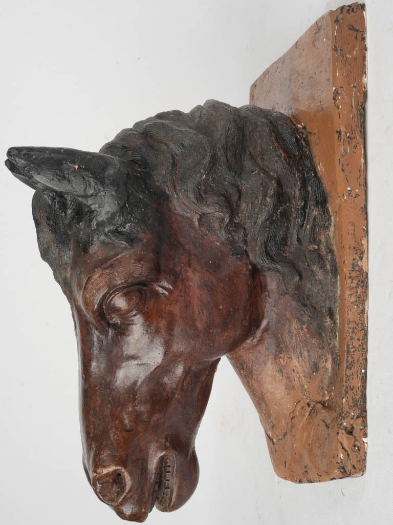 Patina-rich wall-mounted horse sculpture