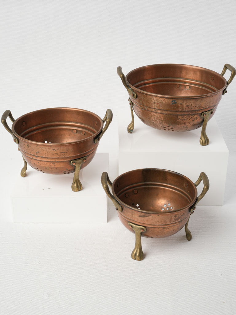 Vintage French copper colander trio