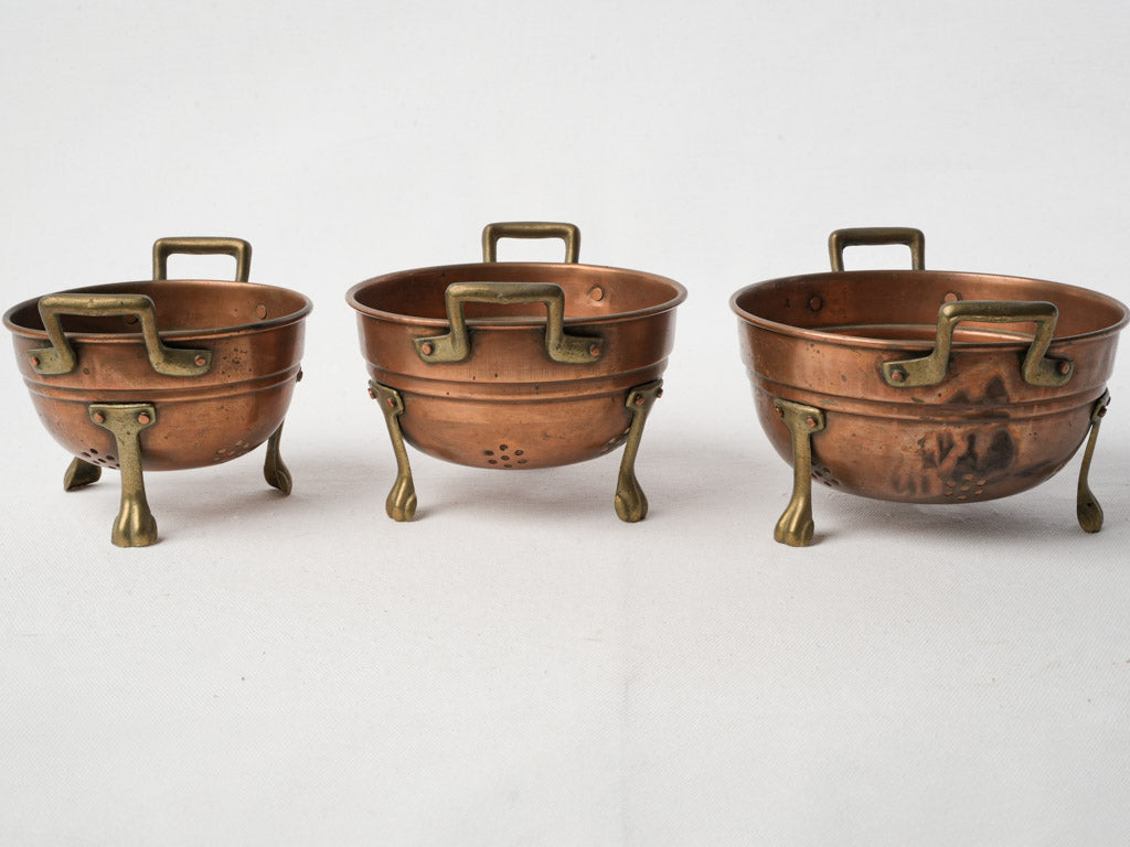 Intricately crafted small copper colanders