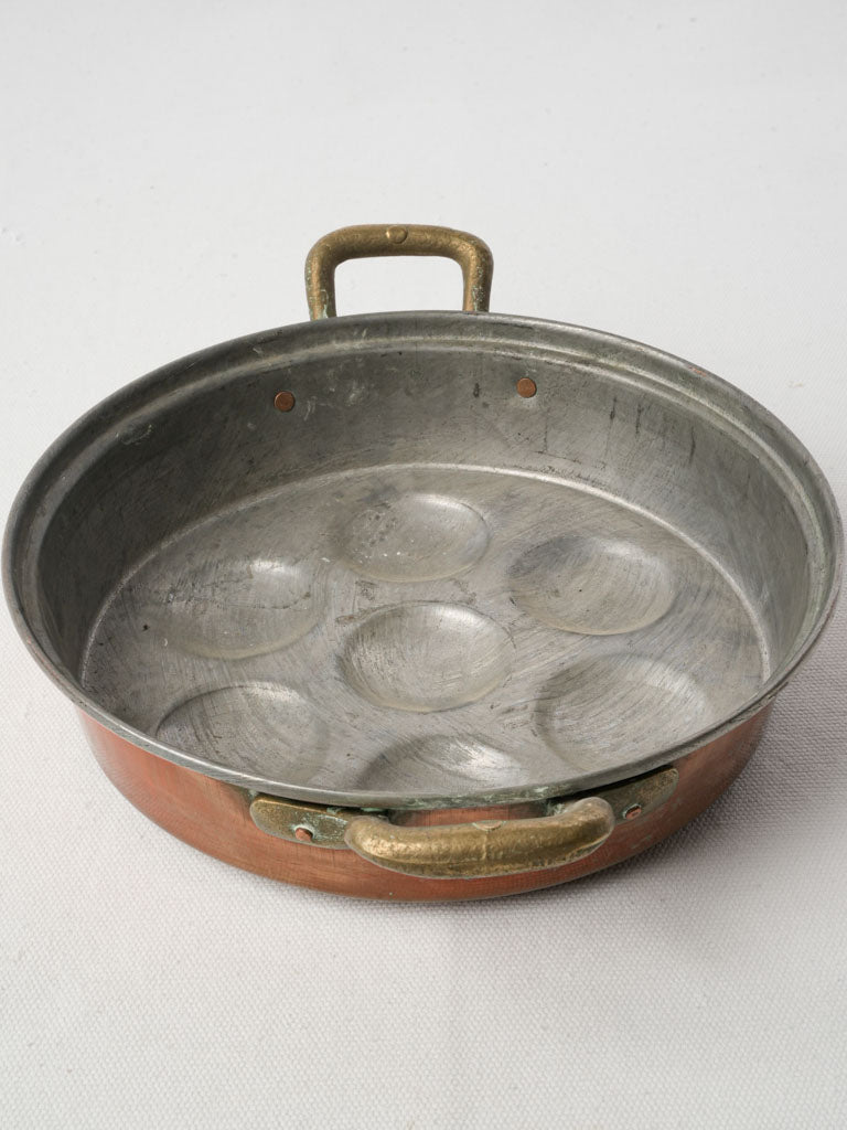 Elegant brass-handled cooking dish