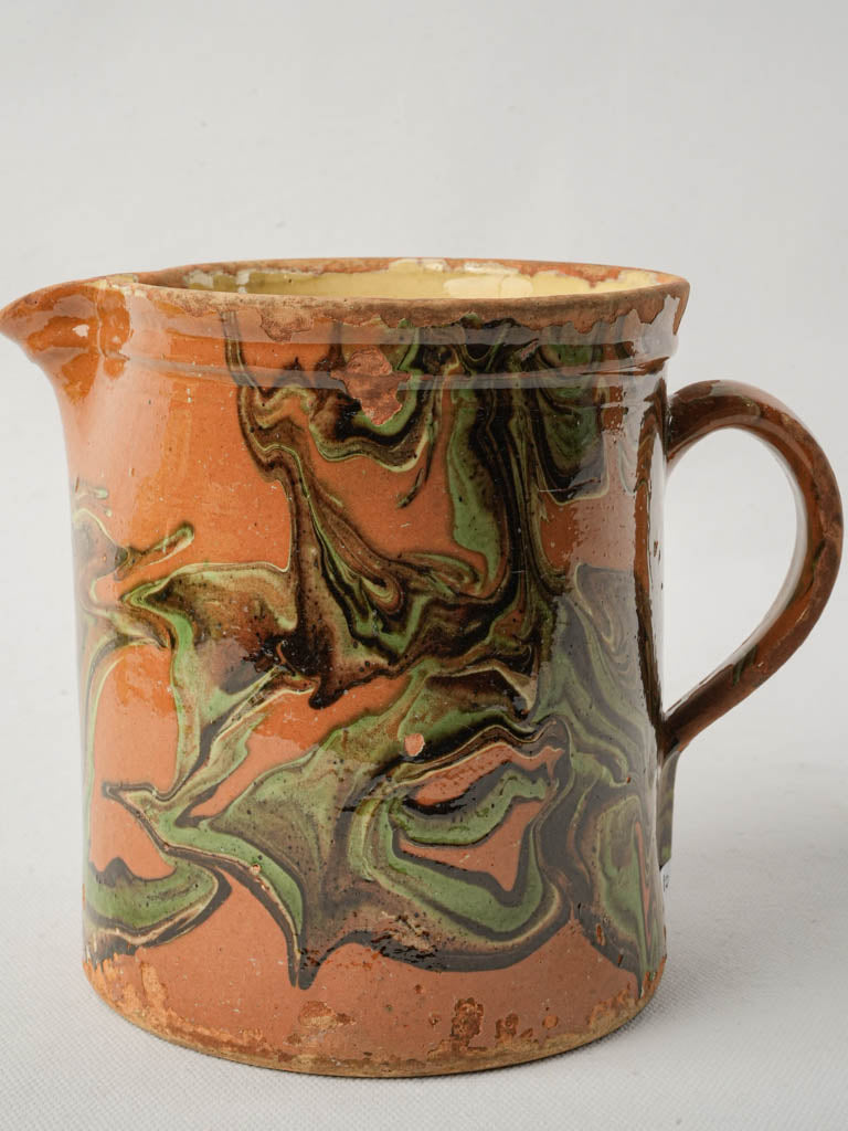 Artisanal jaspe-glazed terracotta jug