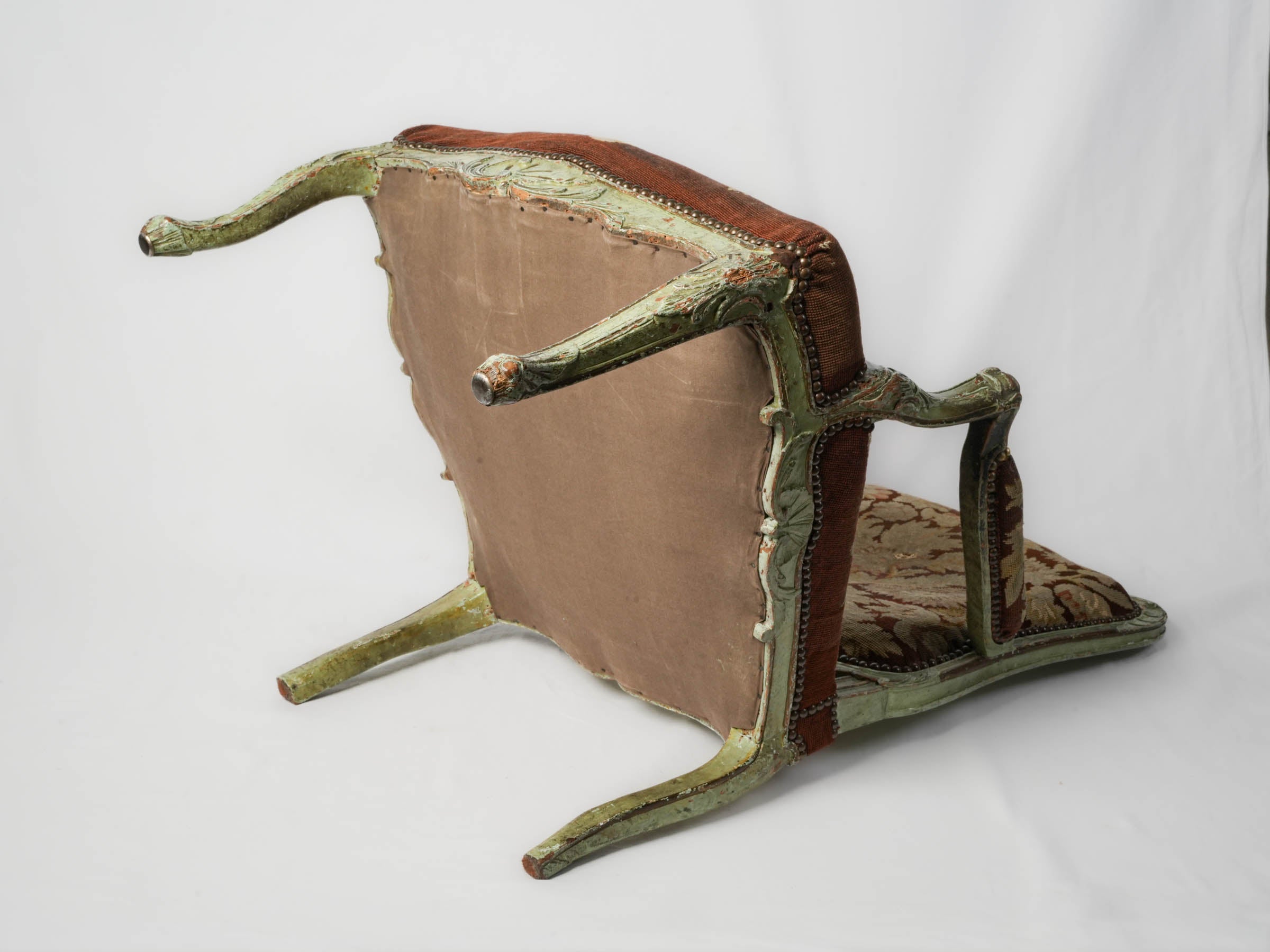 Worn tapestry armchair