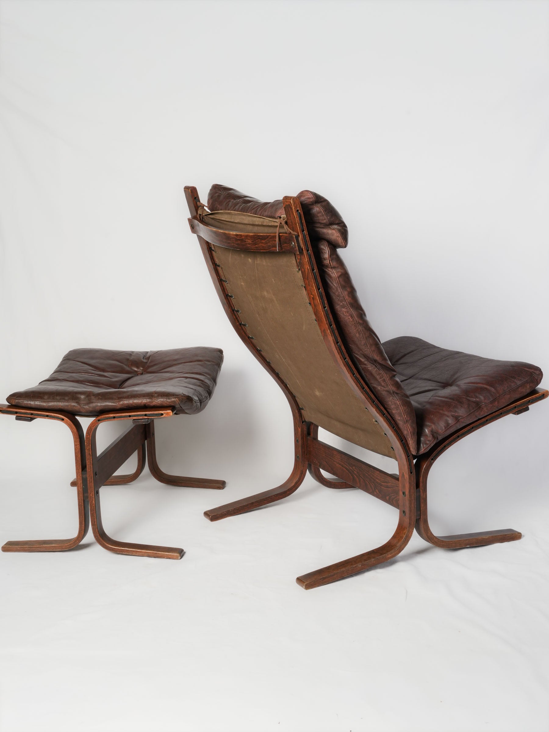 Patinated siesta chairs with ottomans