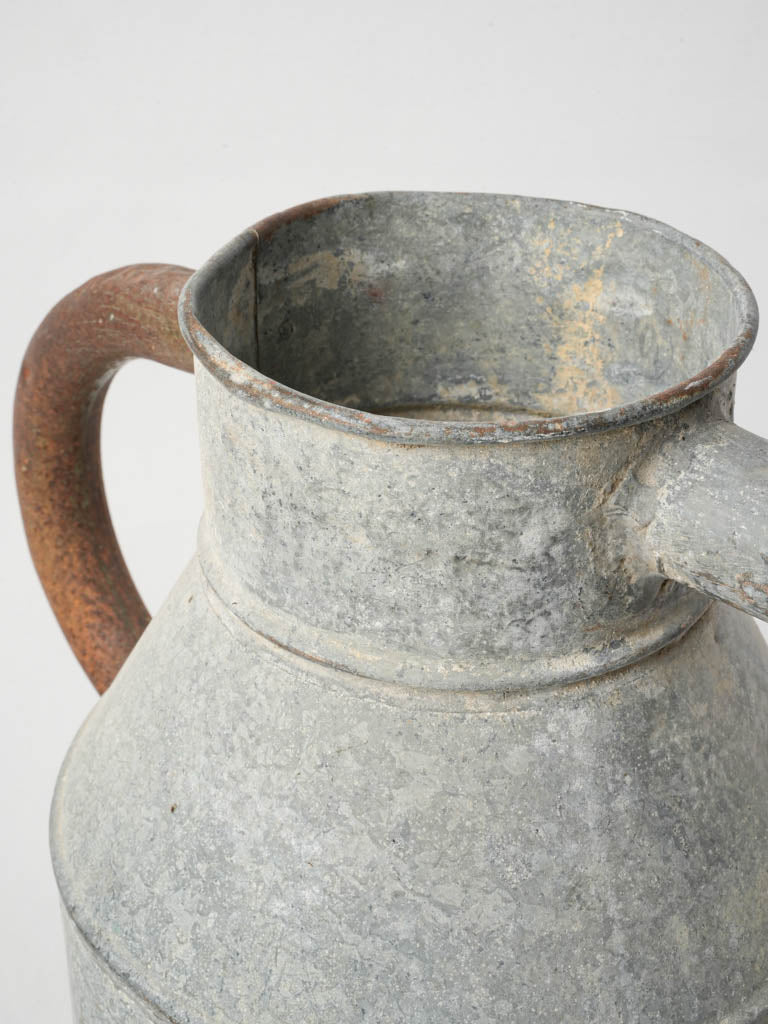 Old-fashioned cylindrical watering can