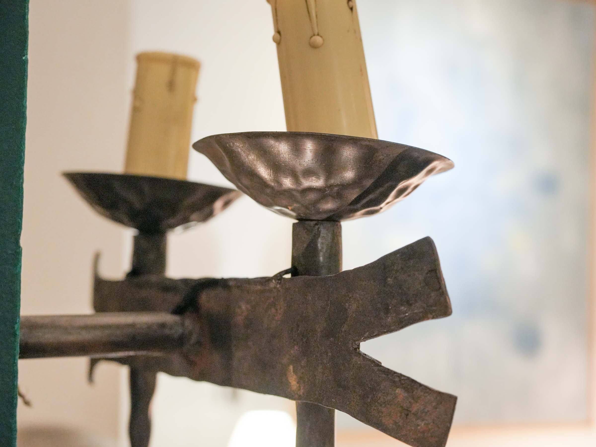 Sculptural candle-style iron sconces