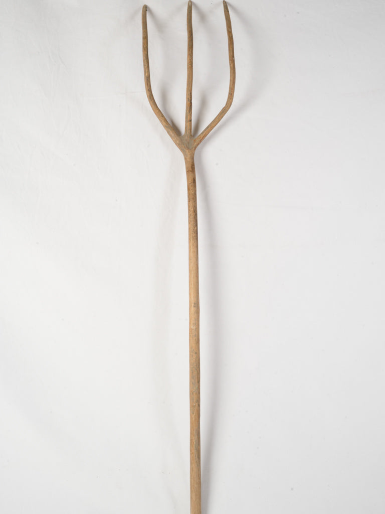 Patinated hand-carved wooden pitchfork