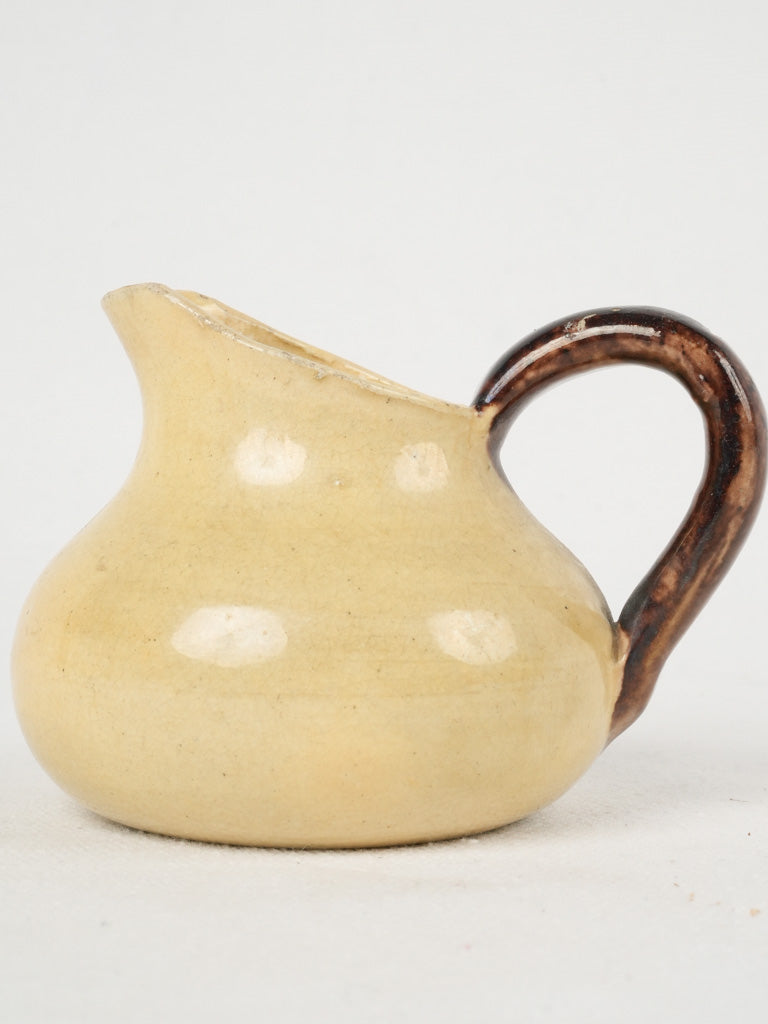 Rustic small yellow-brown ceramic pitcher