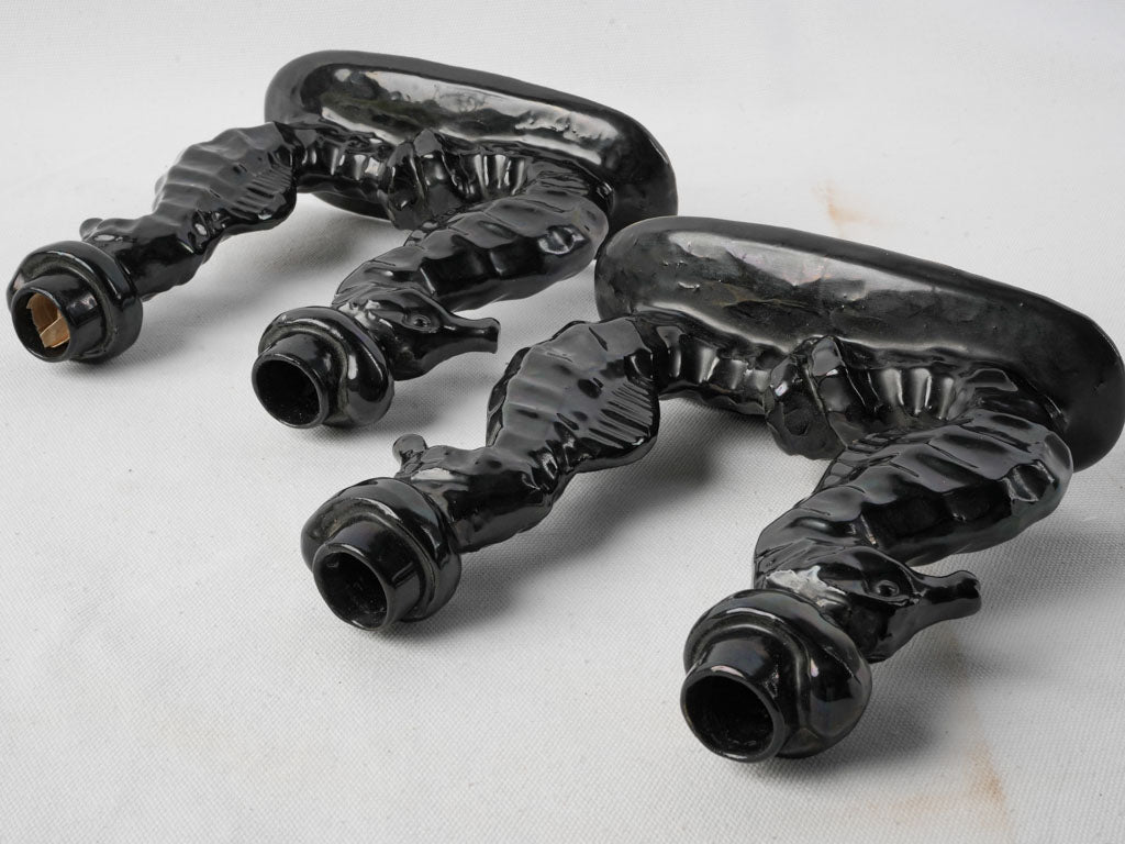 Symmetrical stylized seahorses holders