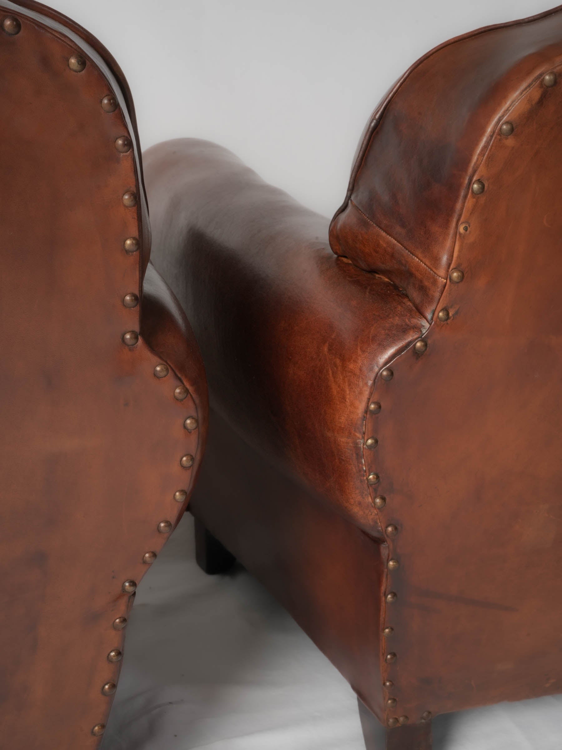 Stunning aged leather club armchairs