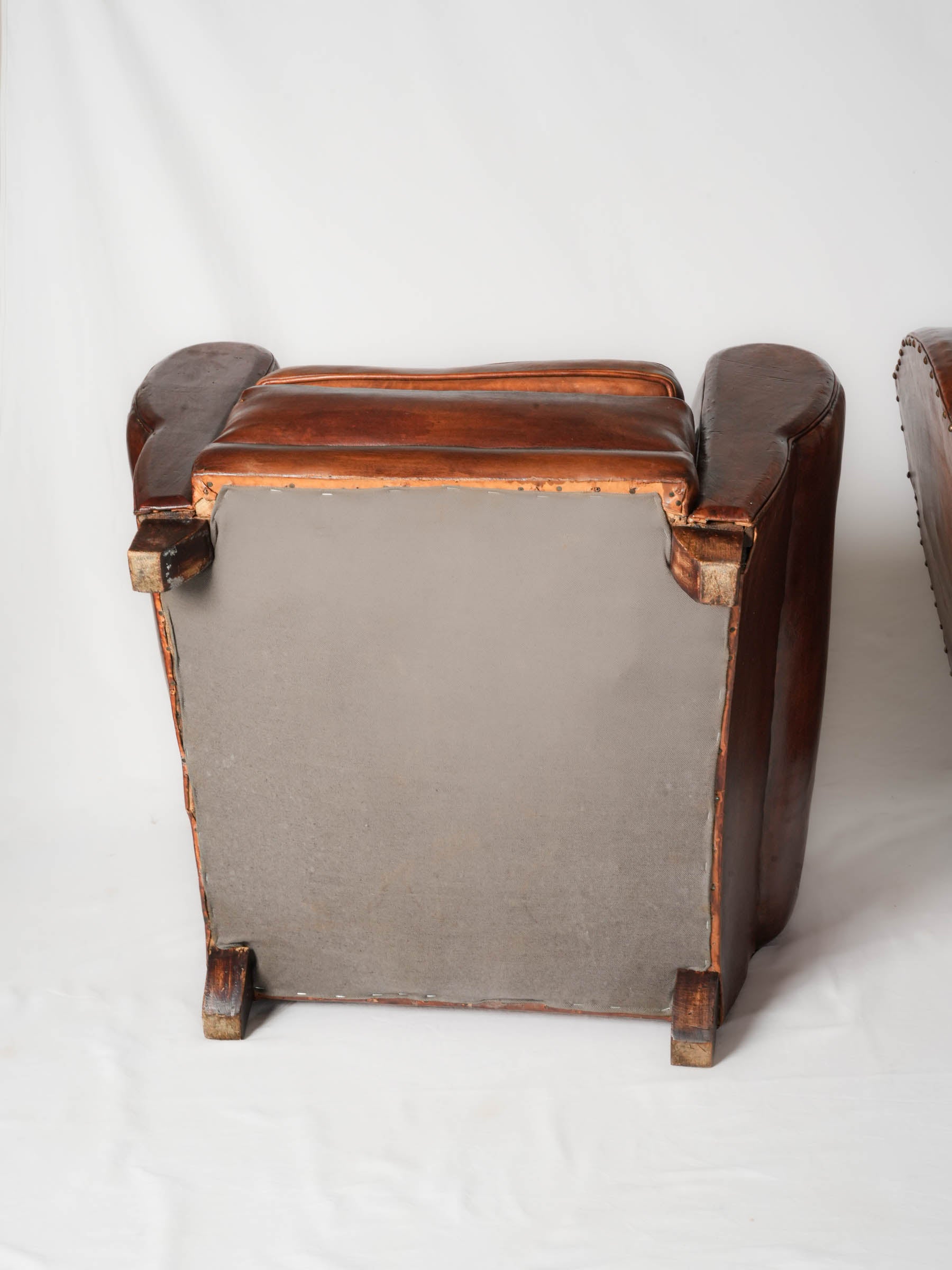 Rich chestnut leather trilobe armchairs