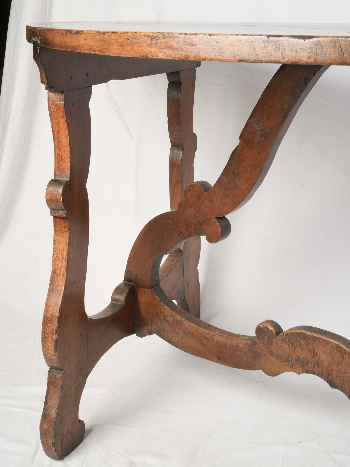 Aged Italian walnut demilune consoles