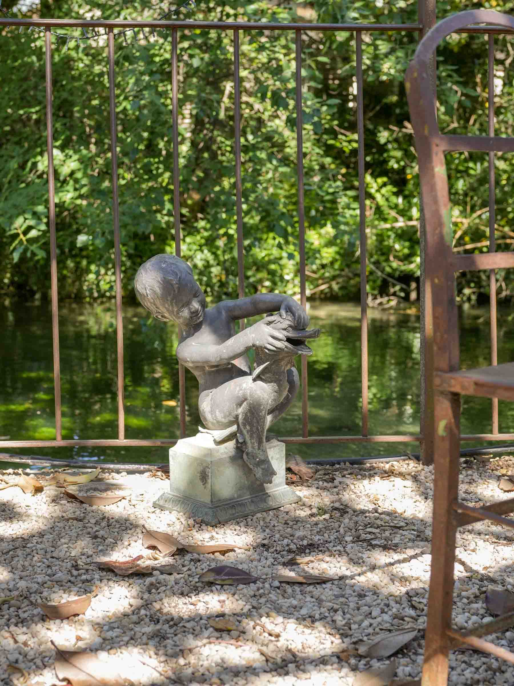 Vintage patinated metal garden statue