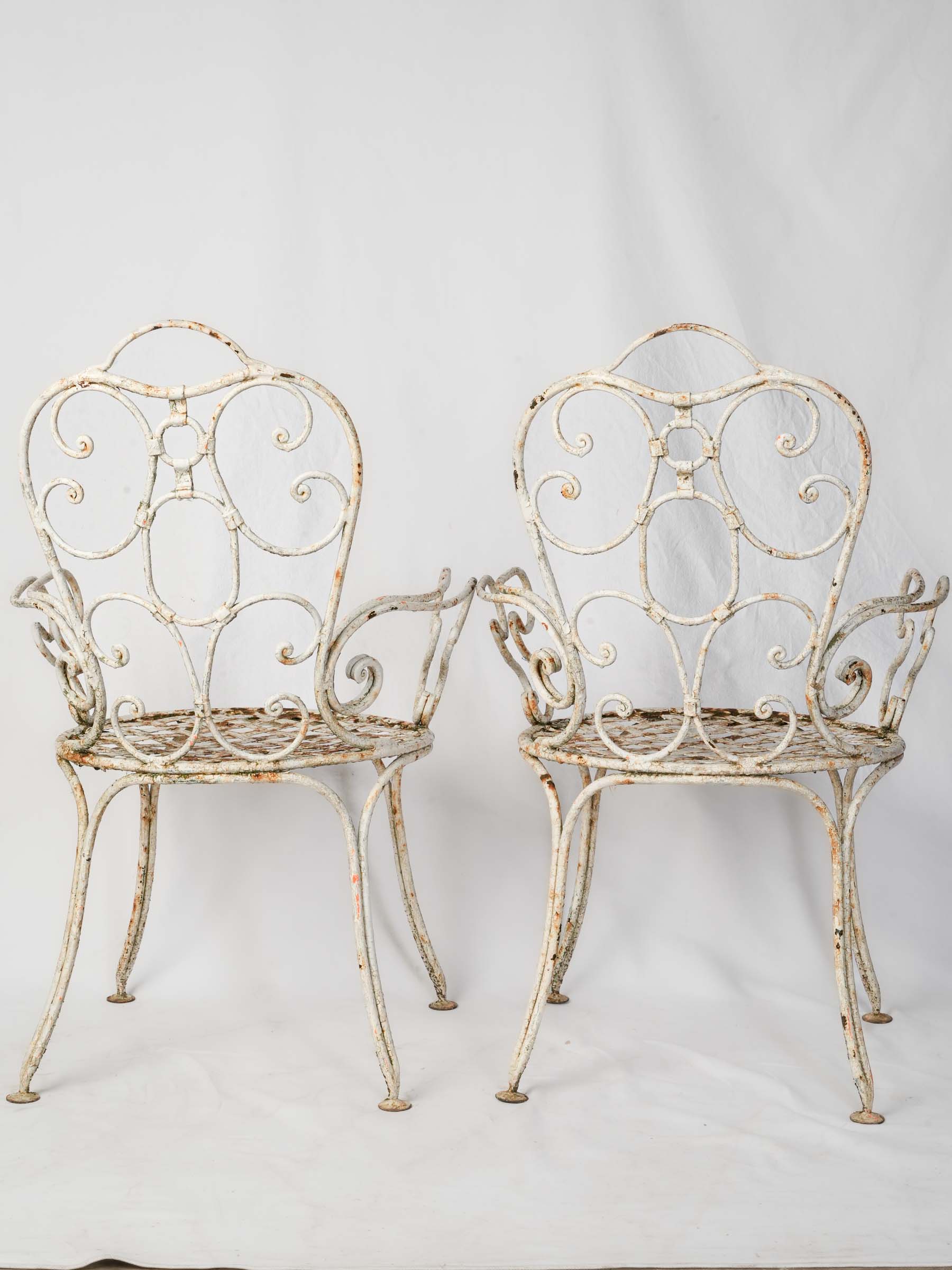 Delicately weathered iron garden chairs