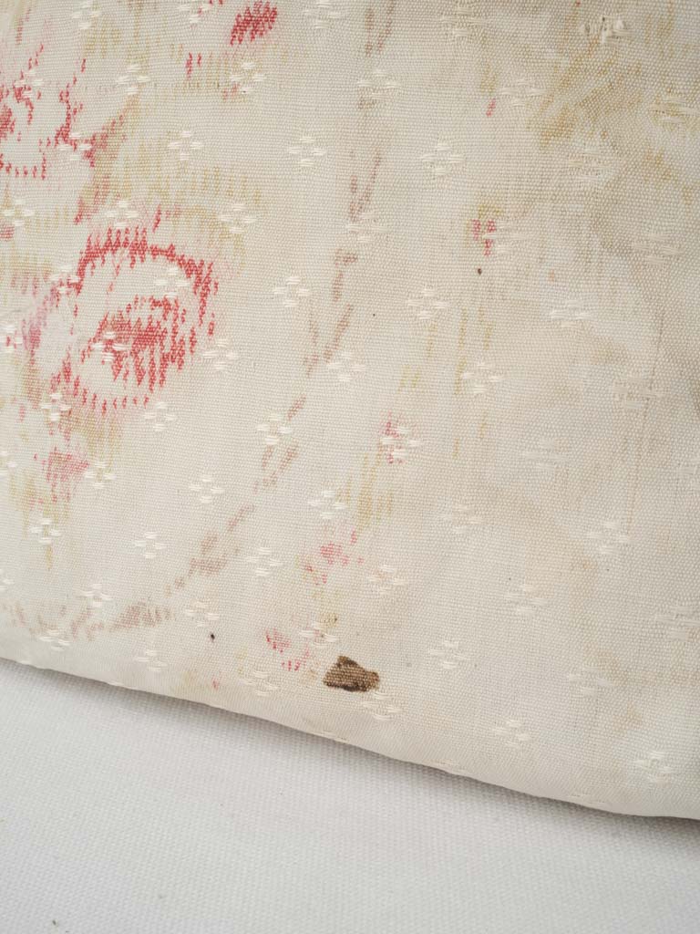 Faded red-trimmed floral pillowcases