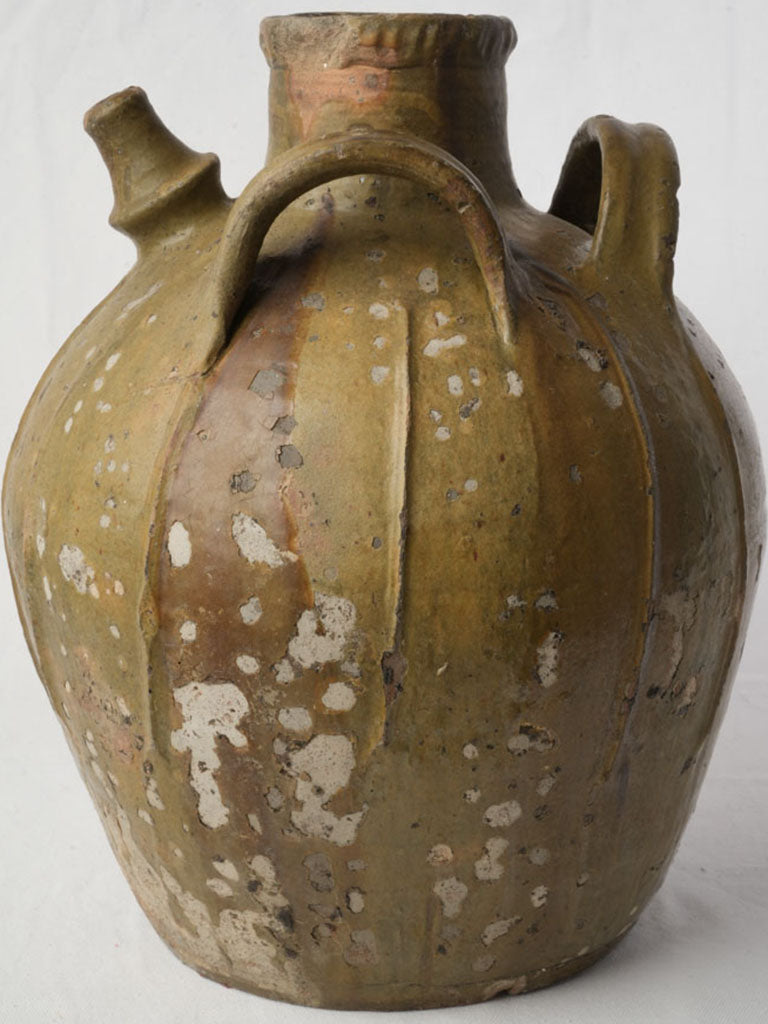 Timeworn sculptural green-glazed jar