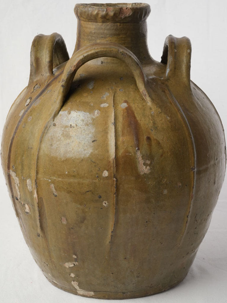 Historic rounded ribbed oil vessel