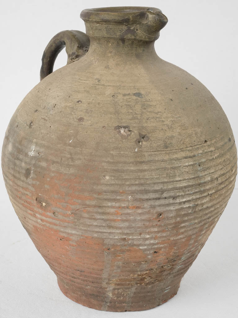 Patina-detailed European half-glazed clay jug
